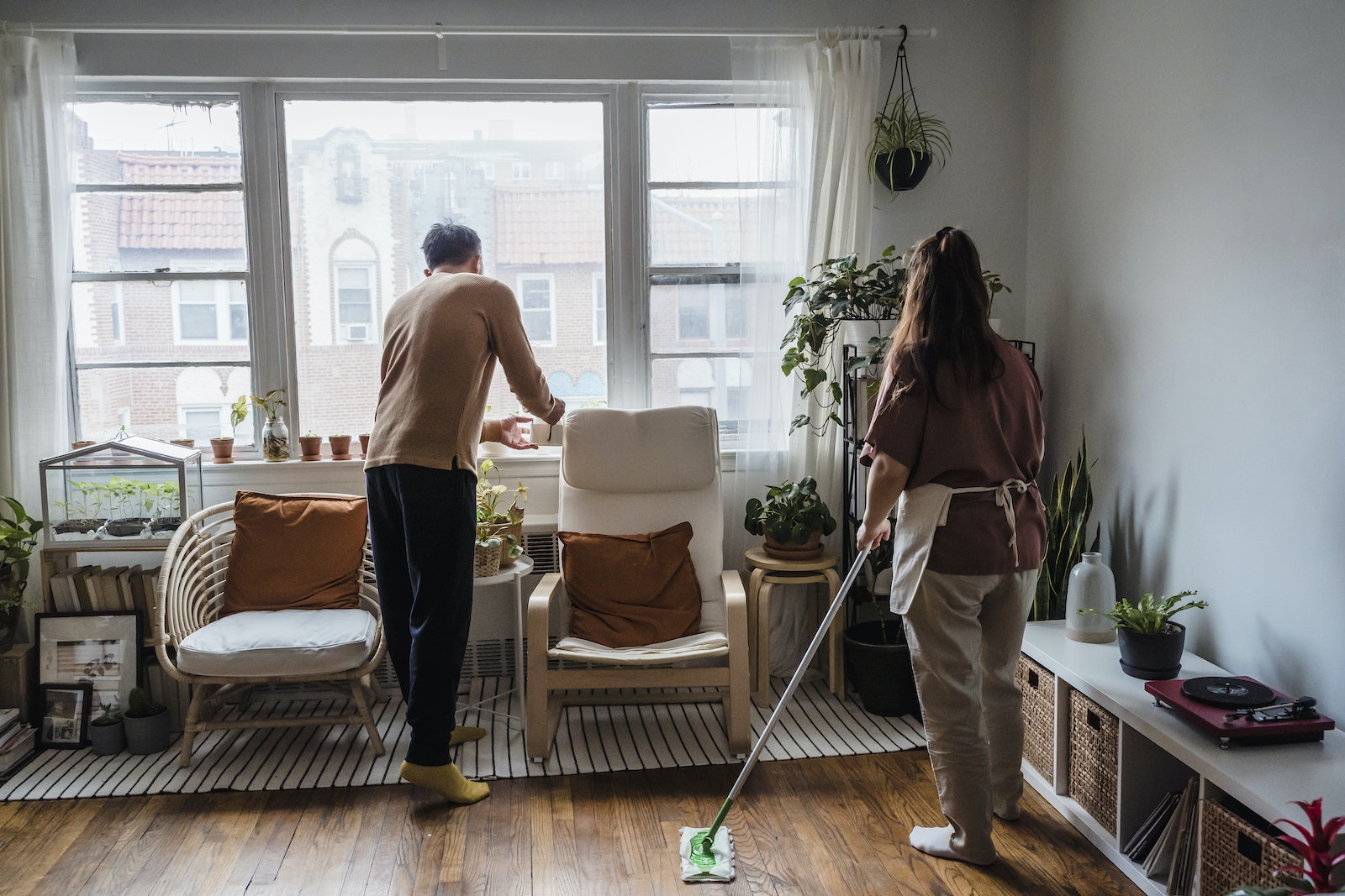 A Couple Cleaning the Living Room